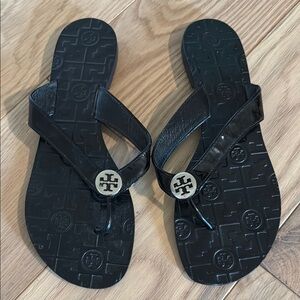 Tory Burch Black Thora Patent Leather Flip-Flops with Silver Logo